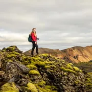 Hikers on a banded rhyolite ridge above the geothermal valley on a guided Landmannalaugar tour in the Fjallabak Nature Reserve, Iceland