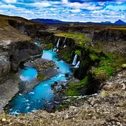 A modified 4x4 crossing the F208 highland track on a full-day Landmannalaugar tour from Reykjavik, Iceland